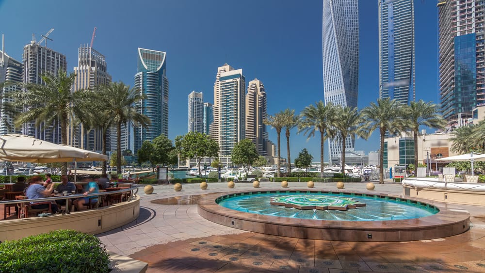 panoramic view with modern skyscrapers and yachts of dubai marina timelapse hyperlapse, united arab emirates
